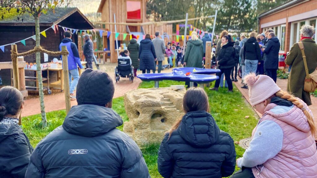 inklusiver Schulhof -Schüler auf Bank Blick auf Schulhof